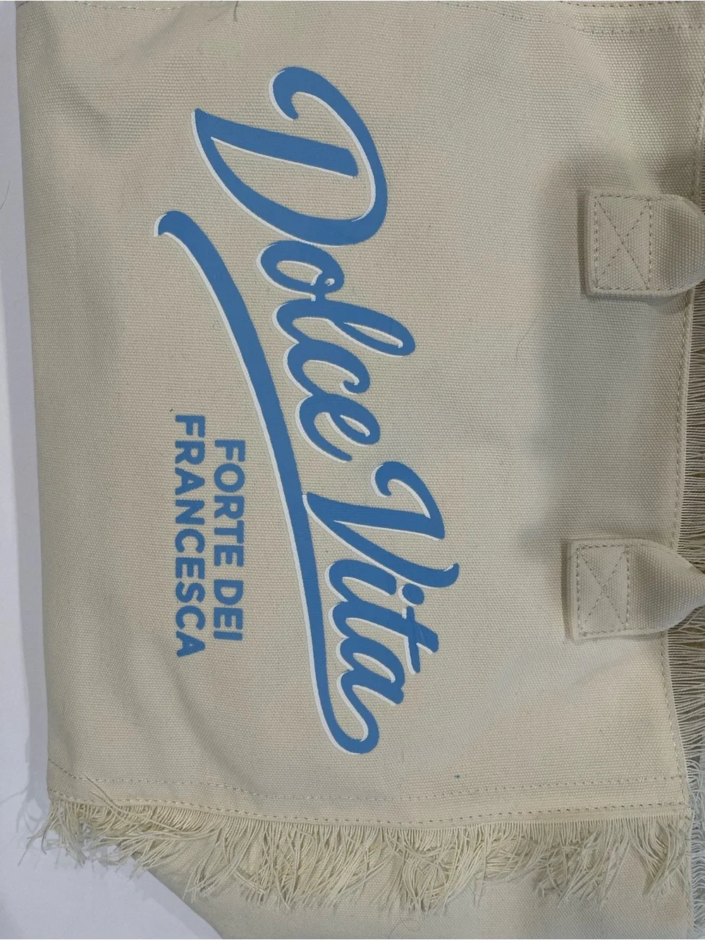Dolce Vita Cream Canvas Fringe Tote with Light Blue Logo